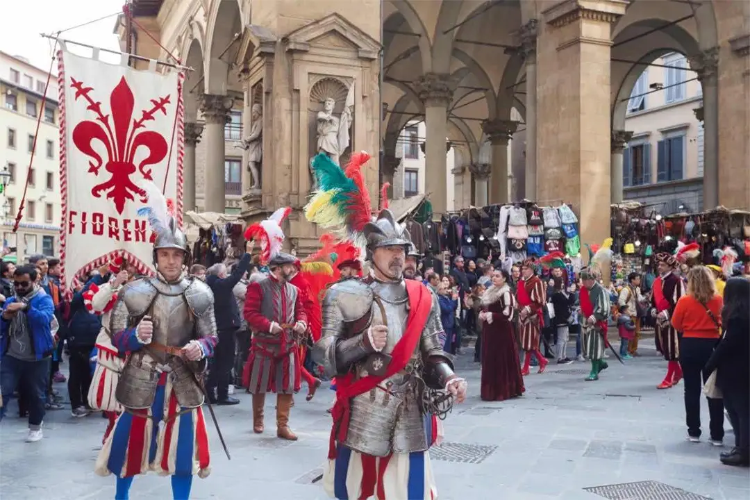 Historical parade with medieval costumes and the flag of Florence during the Capodanno Fiorentino in spring